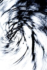 Intentional camera movement (ICM) image of leafless tree branches against cloudy sky in winter...