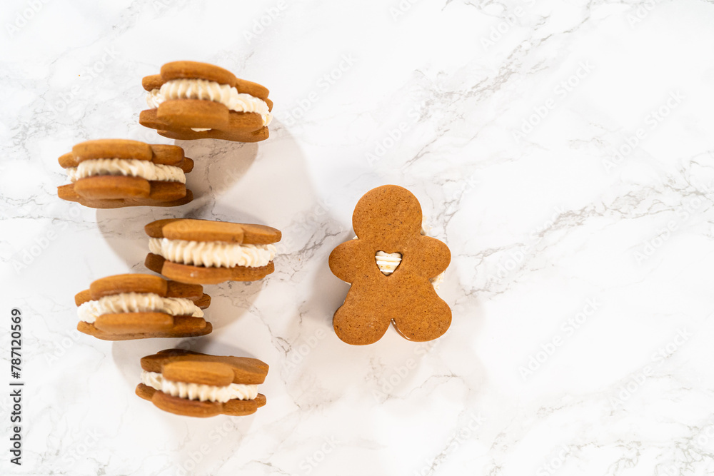 Poster handcrafted gingerbread cookie sandwiches with eggnog buttercream