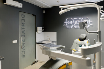 a dental office white sterile ready for robots yellow chair for the patient and white equipment
