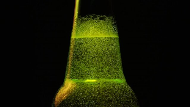 Glowing Green Fizzy Beverage in Dark Ambiance