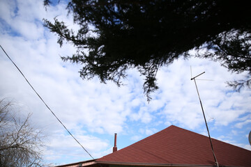 beautiful house roof, brown, against the blue sky

