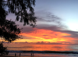 Golden could and sunset light have reflections of the sea and sandy  beach in evening time.