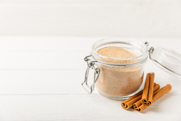 Cinnamon sugar on a texture background. Homemade cinnamon sugar in a bowl on background. Brown sugar. Spice mixture for drinks and baking. Place for text. Copy space.
