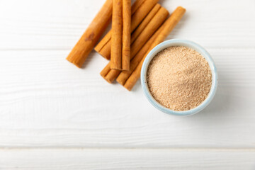 Cinnamon sugar on a texture background. Homemade cinnamon sugar in a bowl on background. Brown sugar. Spice mixture for drinks and baking. Place for text. Copy space.