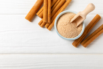 Cinnamon sugar on a texture background. Homemade cinnamon sugar in a bowl on background. Brown sugar. Spice mixture for drinks and baking. Place for text. Copy space.