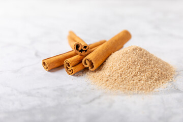 Cinnamon sugar on a texture background. Homemade cinnamon sugar in a bowl on background. Brown sugar. Spice mixture for drinks and baking. Place for text. Copy space.