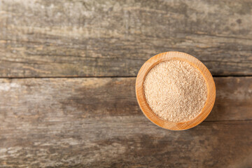 Cinnamon sugar on a texture background. Homemade cinnamon sugar in a bowl on background. Brown sugar. Spice mixture for drinks and baking. Place for text. Copy space.