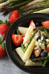 Harmony in Contrast: Strawberry, Asparagus, and Feta Salad with Honey Mustard Dressing on a Grey Background