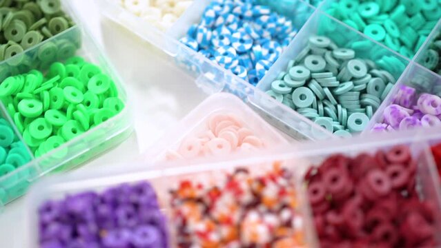 Close-Up View of Multicolored Clay Beads in Organized Sections