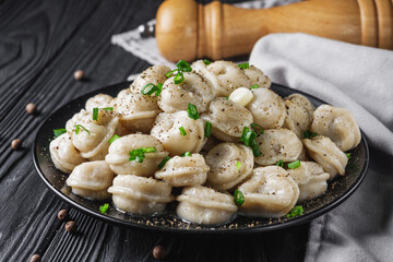 fresh cooked dumplings on a black wooden rustic background