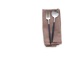 Overhead shot of a brown linen kitchen napkin isolated on white background. Folded cloth for mockup