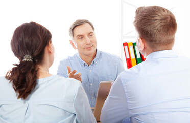 In an office setting, a team of male business professionals is deliberating on company growth strategies. - 787142970