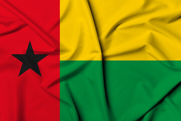 Beautifully waving and striped Guinea-Bissau flag, flag background texture with vibrant colors and...