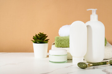 Spa products in the bathroom. Shampoo, cream, towels. Natural cosmetic background. - 787143380