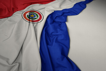 waving national flag of paraguay on a gray background.