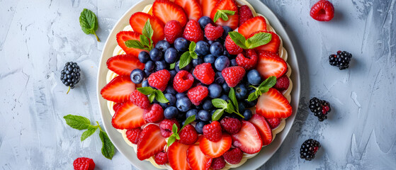 Top view plate of fruit with strawberries, blueberries, and raspberries