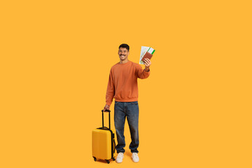 Travel ready guy with suitcase and passport