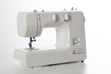 Automatic modern sewing machine with overlock on a white background, isolate. Studio concept. Tailoring services