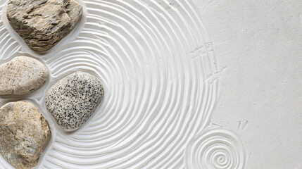 Fototapeta na wymiar Zen rock garden. Circle patterns on white sand top view