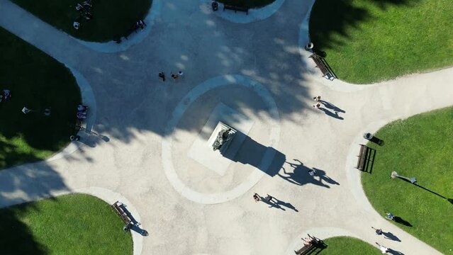 Aerial of the visitors at the Queen Square Park on a sunny day with statue in the middle in Bristol