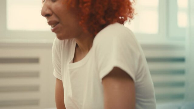 Young African American woman suffering from abdominal pain and period cramps