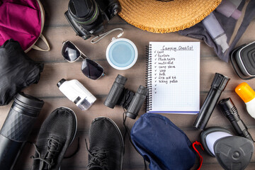 Camping checklist with various camp equipment. List of things for outdoors recreation and travel in nature - tent, first aid kit, cosmetics, accessories, equipment, clothes, trekking shoes - 787166547