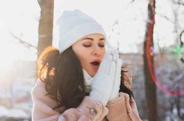 Playful female wearing white hat in winter