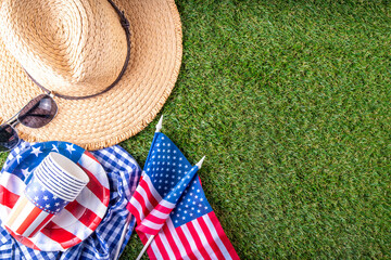 July 4, Independence Day traditional American picnic background. Plates, glasses, USA flags on green lawn or meadow grass, with blanket or tablecloth for picnic, sunglasses, copy space top view - 787167148