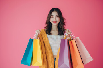 Studio shot of happy woman with shopping bags. Purchases, online shopping, sale concept. Copy space