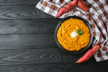 delicious mashed sweet potatoes on a black wooden rustic background