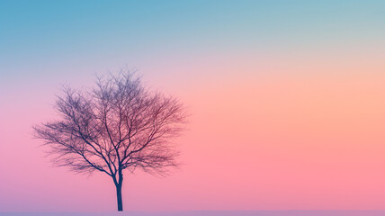 A tree stands alone in a field of pink and purple sky