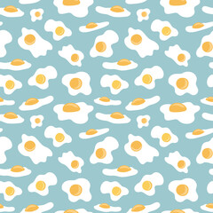 Sunny side up fried eggs on blue green pastel background arranged in seamless pattern. Subtle broken eggs shells surface art design for printing or use in graphic design projects.