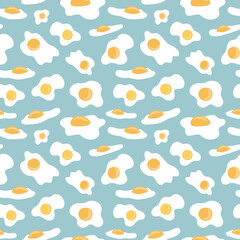 Sunny side up fried eggs on blue green pastel background arranged in seamless pattern. Subtle broken eggs shells surface art design for printing or use in graphic design projects.