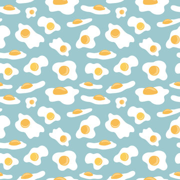 Sunny side up fried eggs on blue green pastel background arranged in seamless pattern. Subtle broken eggs shells surface art design for printing or use in graphic design projects.
