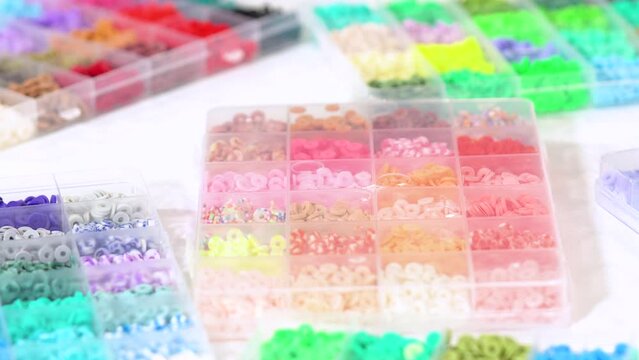 Hands Sort Through Wide Selection of Colorful Crafting Beads