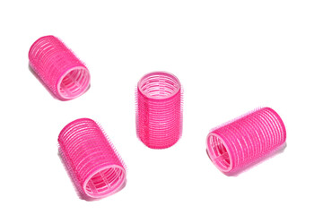 Plastic curlers for creating volume in a woman's hairstyle lie on a transparent background.