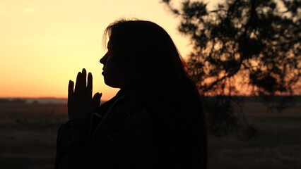 girl woman praying at sunset, hand sunset faith pain, asking heaven for help, spiritual sunset...