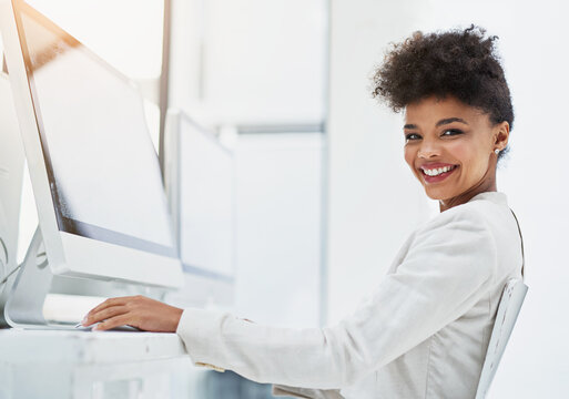 Portrait, black woman and desktop with screen for lens flare, corporate and workplace. Tech, wifi and African face of web designer in bright office with software and wordpress for creative project
