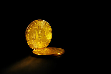 Two bitcoins close-up on a black background. - 787177761