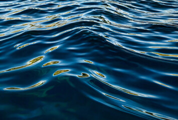 Wave pattern background waves on water surface. View of surface fresh or sea water. Ripples auqa...