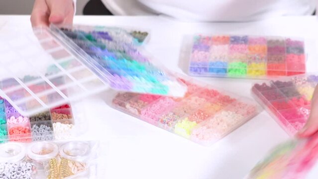 Hands Sort Through Wide Selection of Colorful Crafting Beads