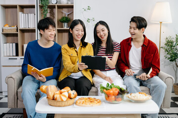 Group of Young Asian friend having, enjoy evening party together at home. Attractive young man and woman having fun, eating food, celebrate at home.