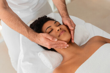 Fototapeta na wymiar Close-up of black lady getting neck massage