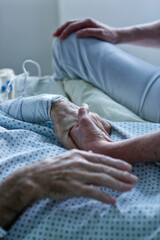 hand of a elderly person, Close-up of senior woman holding hand of her caregiver in hospital	
