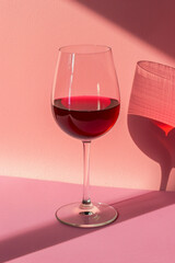 Isolated wine glass with red wine on color background