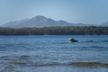 tinny dinghy boat on a river in a national park in the australian bush, On the beach in summer