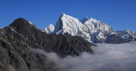 Sea of fog in the Gokyo Valley and peaks of Ama Dablam, Cholatse and Tobuche.