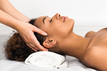 African American woman in a spa head massage