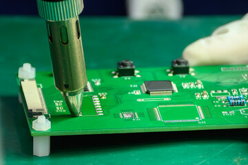 Close up scene the PCB board checking process by operator.