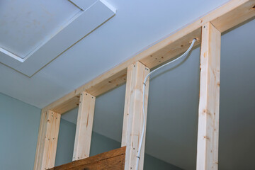 At home renovation site, drywall screws are used to mount plasterboard at wooden beams
